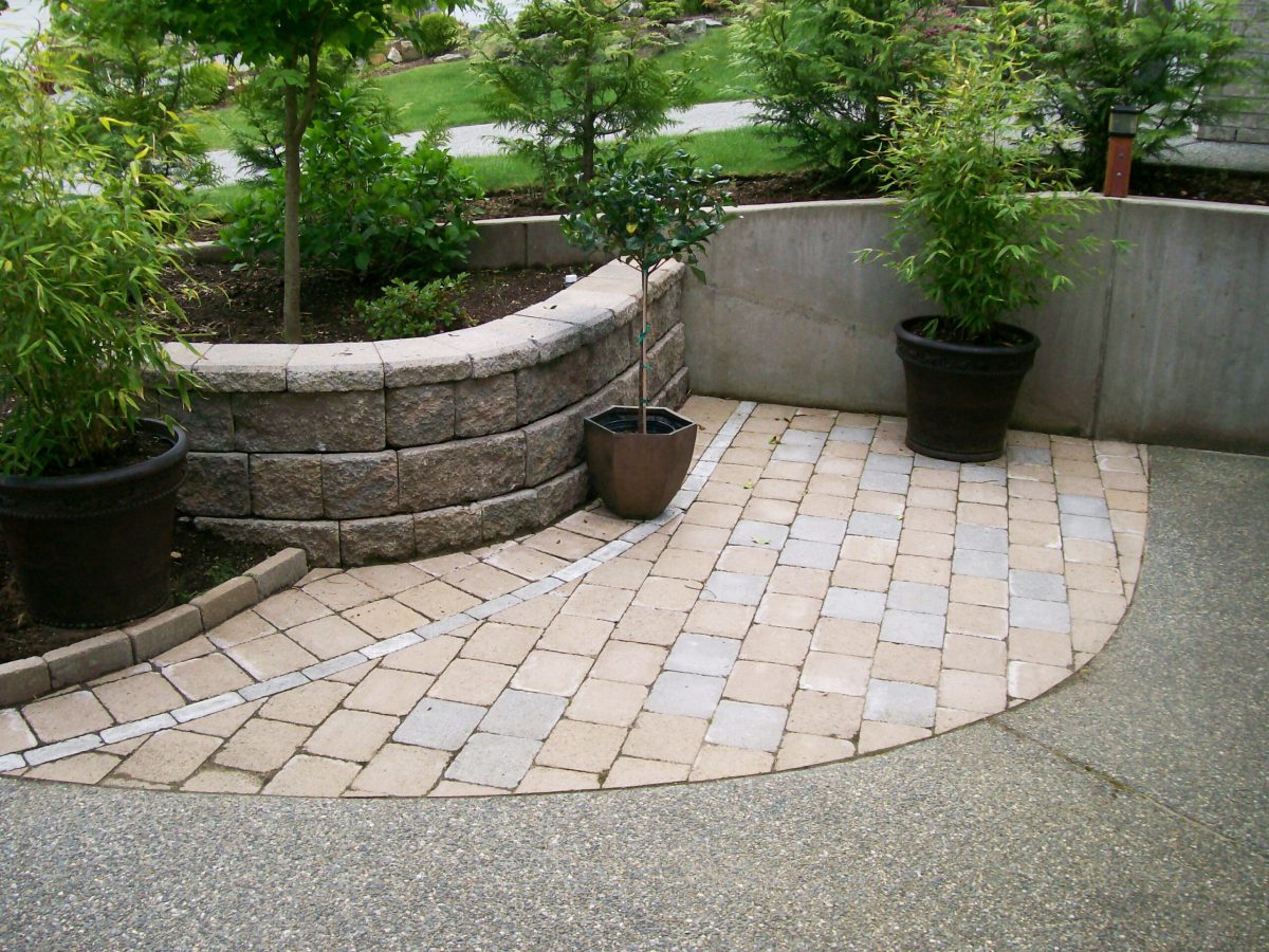 patio with stone planter and shrubs